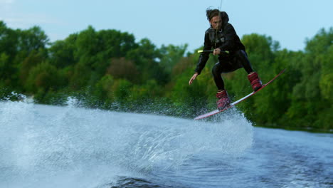Man-riding-board-on-waves-of-river.-Training-process-of-waterskiing