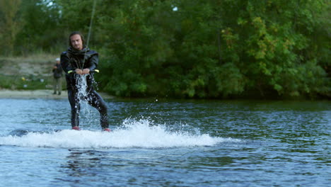Wakeboarder-riding-on-tranquil-water.-Male-rider-extreme-life