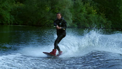 Young-man-wakeboarding-on-river-wave.-Wake-boarding-rider