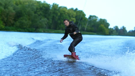 Wakeboarder-waterskiing-on-river-behind-boat.-Wake-boarding-rider