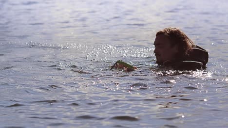 Man-in-waterproof-clothing-preparing-ride-wake-board.-Fail-in-water-sports