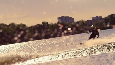 Water-skier-moving-fast-in-splashes-of-water-at-sunset.-Extreme-watersports