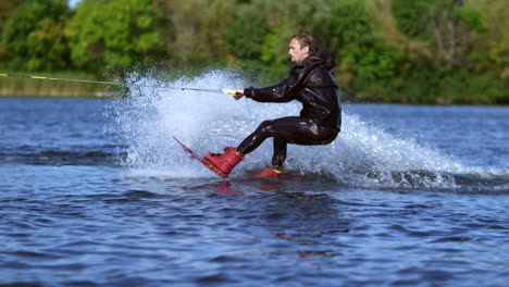 Man-start-wakeboarding-in-slow-motion.-Sportsman-riding-on-wakeboard