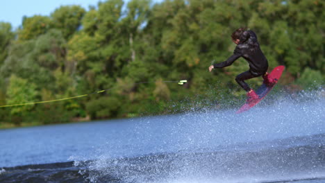 Man-wakeboarder-making-tricks-on-water.-Man-falling-down-in-water