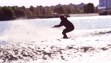 Extreme-rider-jumping-on-wakeboarding-on-city-river.-Extreme-life-style