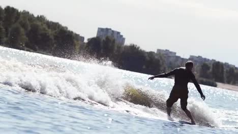 Athletic-man-wake-surfing-on-waves.-Wake-boarding-sport.-Extreme-holidays