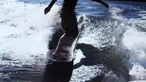 Man-riding-surf-on-waves-of-river.-Wakesurfing-sport.-Extreme-lifestyle
