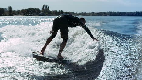 Wake-surfer-falling-in-water-in-slow-motion.-Man-rotating-on-wake-surf