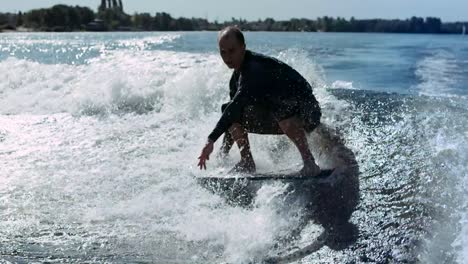 Wake-surfer-falling-in-water-in-slow-motion.-Man-rotating-on-wake-surf