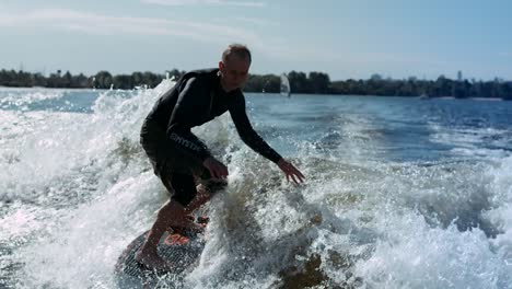 Wake-surfing-rider-enjoy-waves.-Sportsman-surfing-on-waves-in-slow-motion