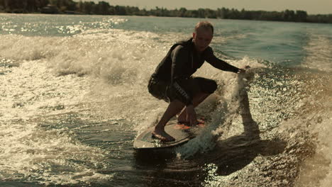 Man-surfing-on-waves-in-slow-motion.-Wake-surfing-rider-enjoy-waves