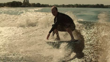 Wake-surfing-rider-training-stunt.-Wakesurfer-falling-into-water