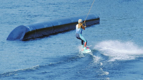 People-enjoys-riding-wakeboard-on-lake.-Young-woman-water-skiing