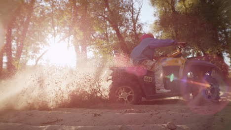 Extreme-driver-dusting-on-ATV-in-slow-motion.-Man-driving-quad-bike-on-sand