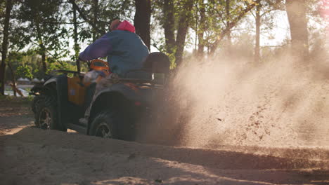 Quad-bike-start-in-slow-motion.-Man-on-atv-starting-with-dust-at-sand-road