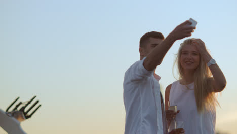 Love-couple-with-glasses-of-champagne-taking-selfie.-Romantic-couple-in-love