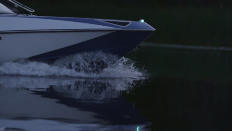 Speedy-motor-boat-floating-on-river-in-evening.-Boat-bow-cutting-water