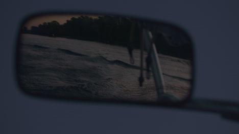 Rear-view-mirror-of-motor-boat.-Water-trail-behind-of-fast-moving-motor-boat