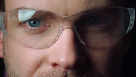 Close-up-portrait-of-young-man-wearing-glasses.-Focused-blue-eyes-of-male.