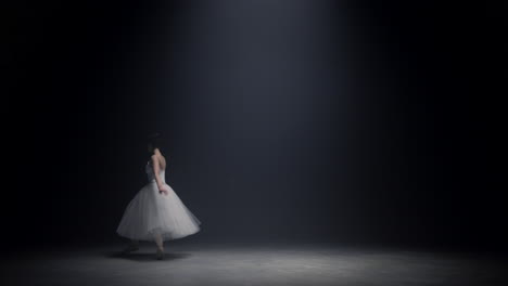 Gorgeous-woman-soaring-in-ballet-dress-on-stage.-Ballerina-dancing-indoors.