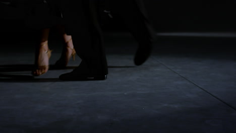 Ballroom-couple-feet-moving-on-stage.-Unrecognizable-man-woman-legs-dancing.