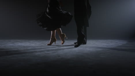 Dancers-legs-doing-movements-on-floor.-Dance-couple-feet-dancing-indoors.