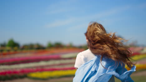 Back-view-of-happy-girl-with-long-beautiful-hair-running-in-slow-motion-outdoor