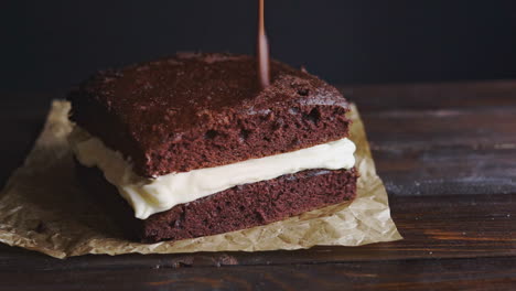 Chocolate-icing-on-cake.-Chocolate-glaze-pouring-on-homemade-dessert