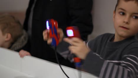 Boy-boxing-with-gamepad-in-hands.-Kid-remote-controlling-robot