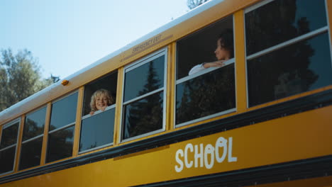 Schoolchildren-looking-out-bus-window-in-morning.-students-standing-in-schoolbus