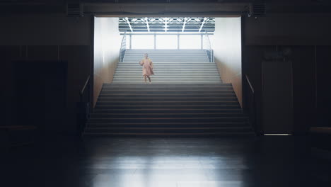Little-girl-running-down-empty-school-staircase-alone.-Child-rush-to-classroom.