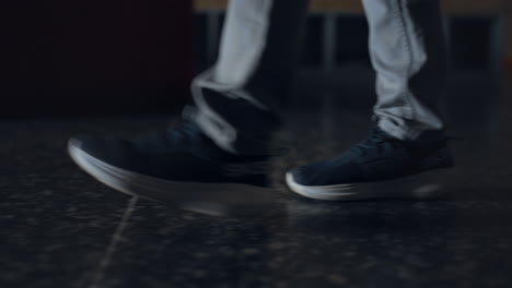 Closeup-student-legs-walking-on-marble-school-floor.-Boy-going-on-empty-corridor