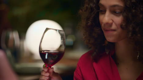 African-american-woman-drinking-wine-glass-in-fine-dining-restaurant-on-date.