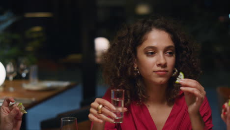 African-american-girl-drinking-shot-on-friends-meeting-at-fancy-restaurant-bar.